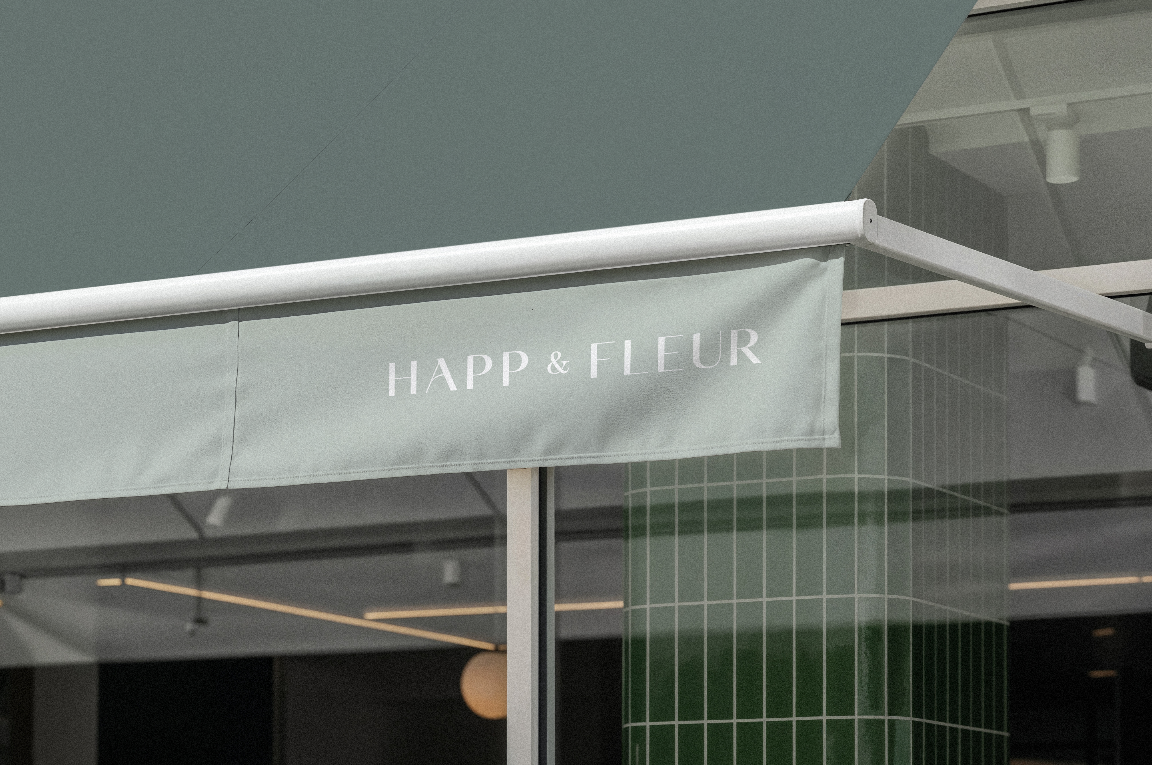 Anders brand wordmark in white placed on top of an image of a modern interior design.